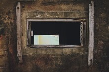 Old Window Having Shutter Broken Of An Abandoned Building