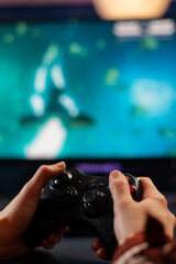 Canvas Print - Close up of wireless joystick, gamer playing online videogames for live gamers tournament. Professional pro player streaming online video game new graphics using powerful computer.