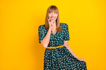 Canvas Print - Portrait of attractive curious cheerful blonde girl thinking posing biting nail isolated over bright yellow color background