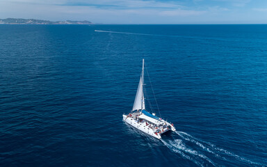 Aerial shot of yacht cruise at sea in Ibiza Spain