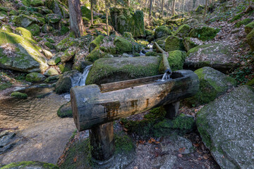 Sticker - Tube with water source through big rocks in the forest