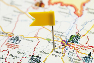 MYKOLAIV, UKRAINE - NOVEMBER 09, 2020: Kyiv city marked with push pin on map of Ukraine, closeup