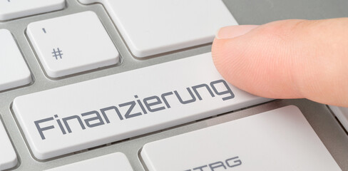 Wall Mural - a keyboard with a labeled button - financing in german - finanzierung