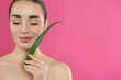 © New Africa - Young woman with aloe vera leaf on pink background. Space for text