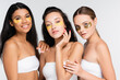 © LIGHTFIELD STUDIOS - multiethnic young women in eye patches smiling isolated on white