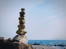 Stack Of Stones On Beach Against Sky