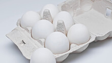 Fresh Chicken Eggs In Cardboard Container On White Surface