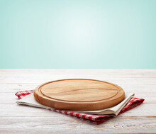 Napkin And Board For Pizza On Wooden Desk. Kitchen Background.