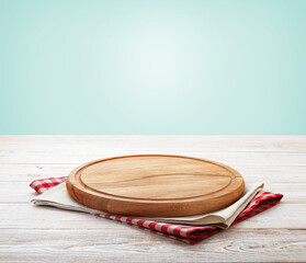 Napkin and board for pizza on wooden desk. Kitchen background.