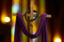 Wooden Cross, Crown Of Thorns And Purple Fabric