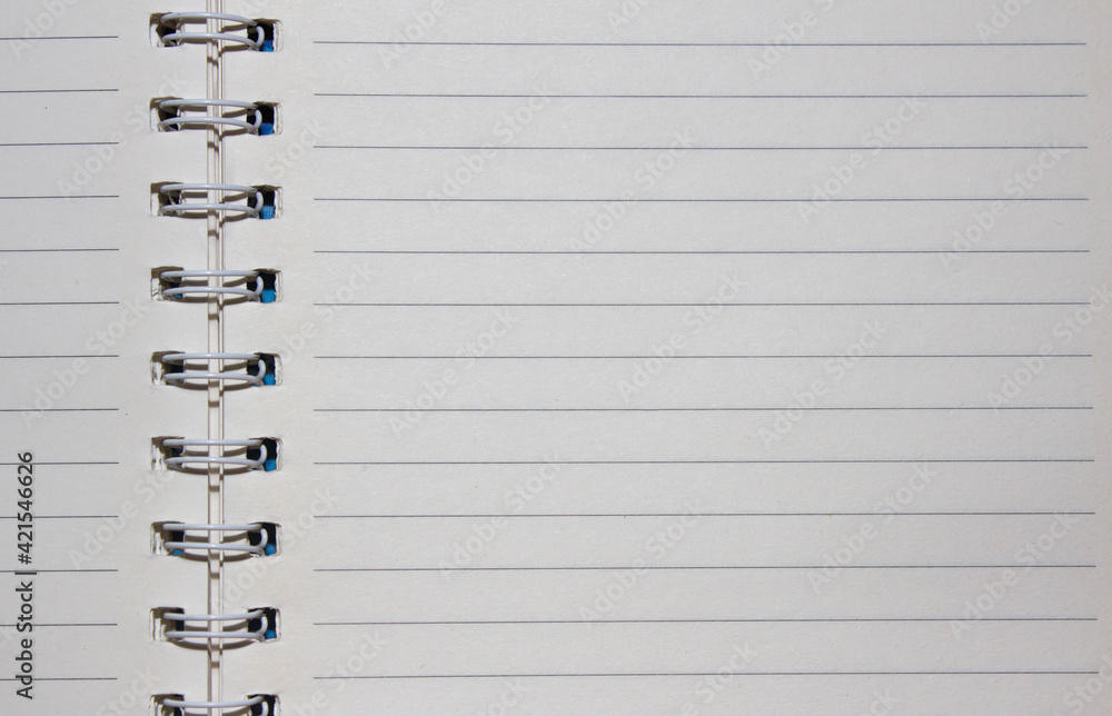 Notebook on a spiral spring with textured papper of white color as the ...