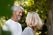 © PhotoAlto - Smiling mature couple looking at each other in backyard