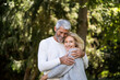 © PhotoAlto - Smiling mature couple embracing each other in backyard