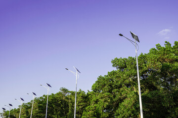 Wall Mural - solar cell lamp electricity system for alternative power energy on street with green tree nature, fu