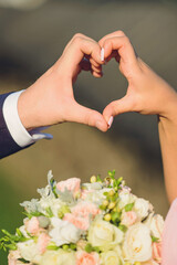 Wall Mural - couple holding fingers in heart form