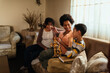 © bernardbodo - Hispanic family chatting in the living room