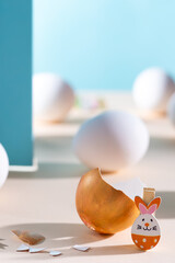 Wall Mural - Broken golden egg with easter bunny on blue background