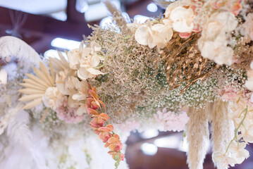 Wall Mural - Close up of floral decor table on the venue. Beautiful flowers hanging down.