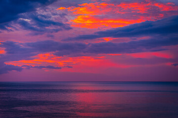 Wall Mural - Purple sky over the ocean at sunrise
