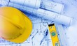 © BillionPhotos.com - Paper blueprints, a yellow hardhat and tools