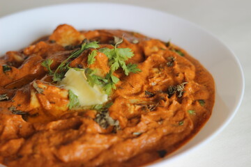 Wall Mural - Cottage cheese cubes in a rich smooth gravy of tomatoes, cashew nuts, spices. Locally known as Butter paneer.