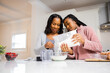 © B. Alyssa Trofort/Creative Flame - Mother and daughter preparing breakfast pancakes in the morning