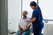 © Gerald R Carter Jr/Creative Flame - Black nurse takes vitals of black female patient in exam room at medical facility