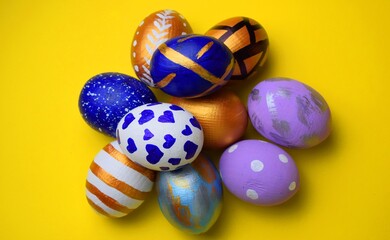 Wall Mural - Easter eggs isolated on yellow background