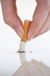 © Tetra Images/Tetra Images - Hand putting out cigarette