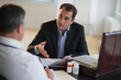 © Tetra Images/Tetra Images - USA, New Jersey, Jersey City, Medical sales representative talking with doctor in office