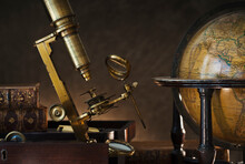 Old Microscope And Globe
