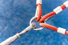 Closeup Shot Of Three Red Ropes Attached To A Ring