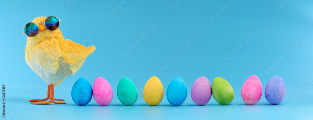 Easter decoration of a yellow chick wearing silly sunglasses with a row of colorful painted Easter eggs. - obrazy, fototapety, plakaty 