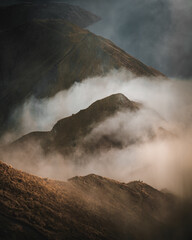 Poster - Vertical shot of rocky mountains covered with clouds