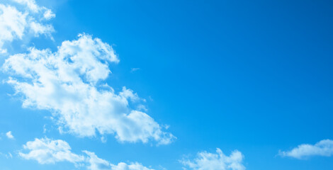 Wall Mural - beautiful scene, white fluffy clouds floating smoothly over bright blue sky in summer day. panorama 