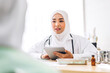 © Art_Photo - Muslim asian woman doctor service help support discussing and consulting talk to muslim woman patient at meeting health medical care express trust concept in hospital.healthcare and medicine