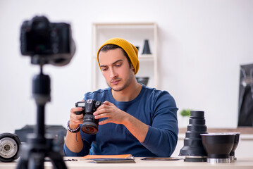 Young male photographer recording video for his blog