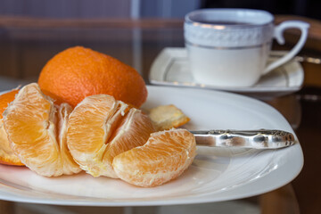 Wall Mural - Orange slices on a white plate. Selective focus. Close-up.