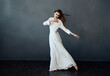 © SHOTPRIME STUDIO - attractive woman in white dress dance performance charm gray background model