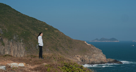 Wall Mural - Woman stand at the top of mountain