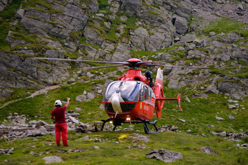fagaras, arges/romania - 08/02/2020: rescue helicopter on top of the mountain trying to land urgentl