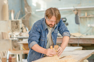 Wall Mural - Carpenter planed wood in a workshop