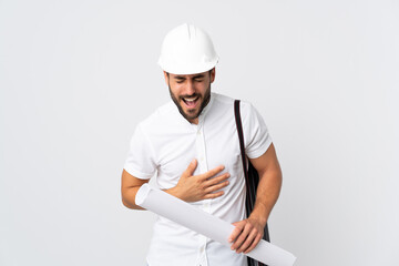 Poster - Young architect man with helmet and holding blueprints isolated on white background smiling a lot