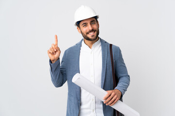 Wall Mural - Young architect man with helmet and holding blueprints isolated on white background showing and lifting a finger in sign of the best