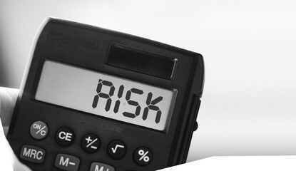 Wall Mural - Calculator with the word risk on the display. Investment business concept