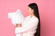 © luismolinero - Young Asian woman in pajamas isolated on pink background with happy expression