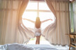 © tong2530 - Young asian woman stand open white curtains at the window, the morning after waking up in the bedroom of her home. Woman wake up with a fresh and open the curtains on the windows.