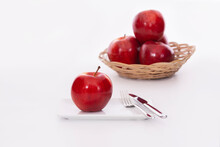 Delicious Looking Red Apple On A Plate With Cutlery