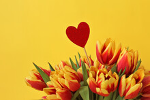 One Wooden Red Heart And Tulips On Yellow Background