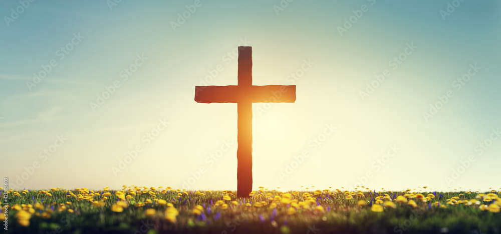 Cross on spring meadow religion and faith - obrazy, fototapety, plakaty 